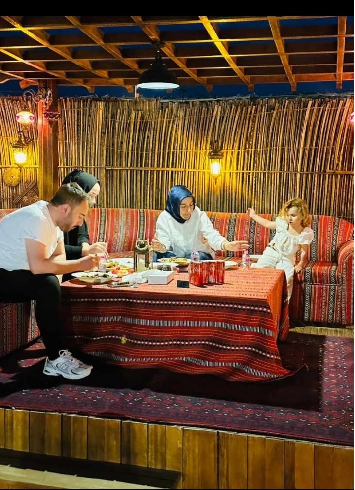 Family enjoying dinner during a desert safari by Royal Viking Tourism.