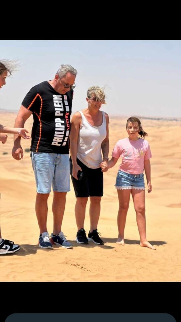 Family walking in the desert during Dubai desert safari by Royal Viking Tourism.