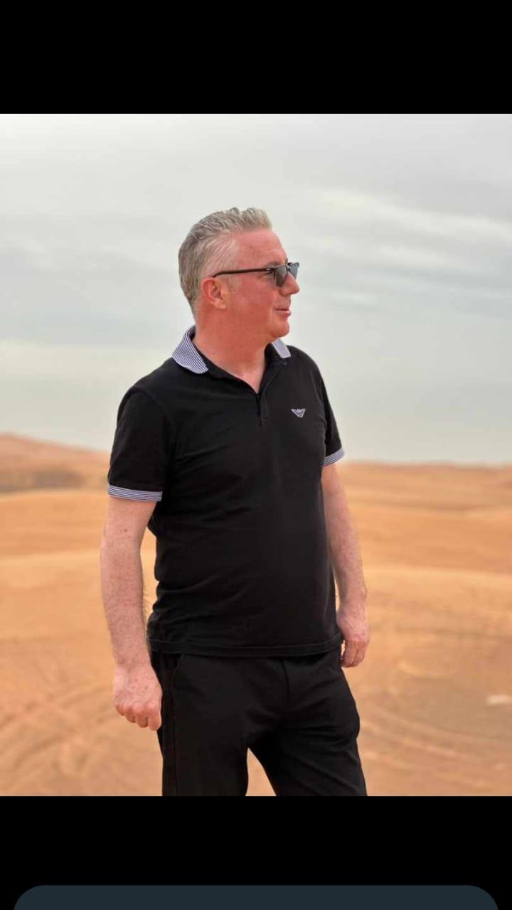 Man enjoying the serene desert landscape during Dubai desert safari by Royal Viking Tourism.