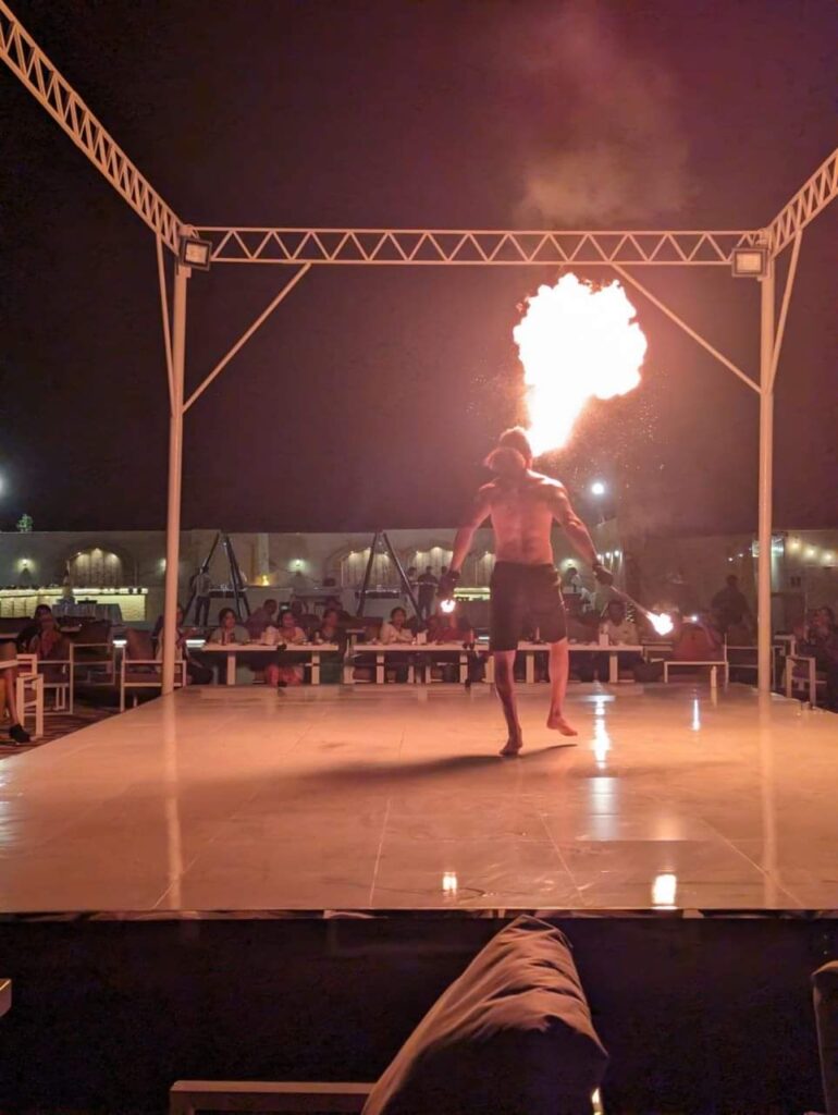 Fire show performance during a desert safari night by Royal Viking Tourism.