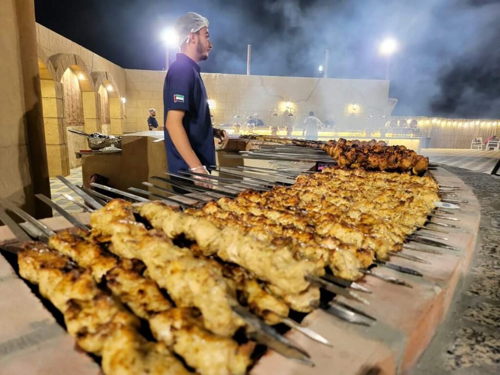 Grill master at work during a desert barbecue by Royal Viking Tourism.