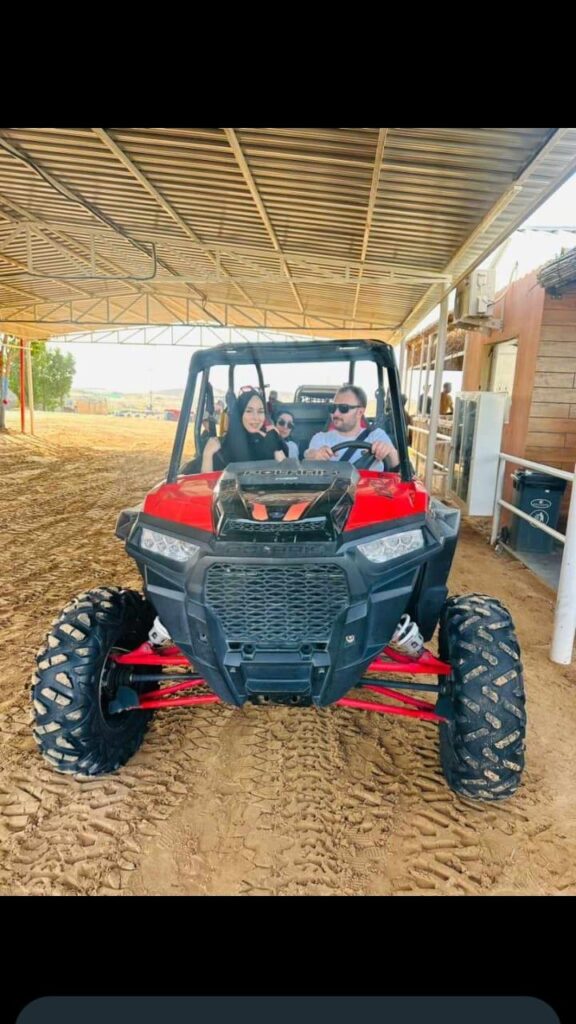 Family enjoying an ATV ride during a Dubai desert safari by Royal Viking Tourism.